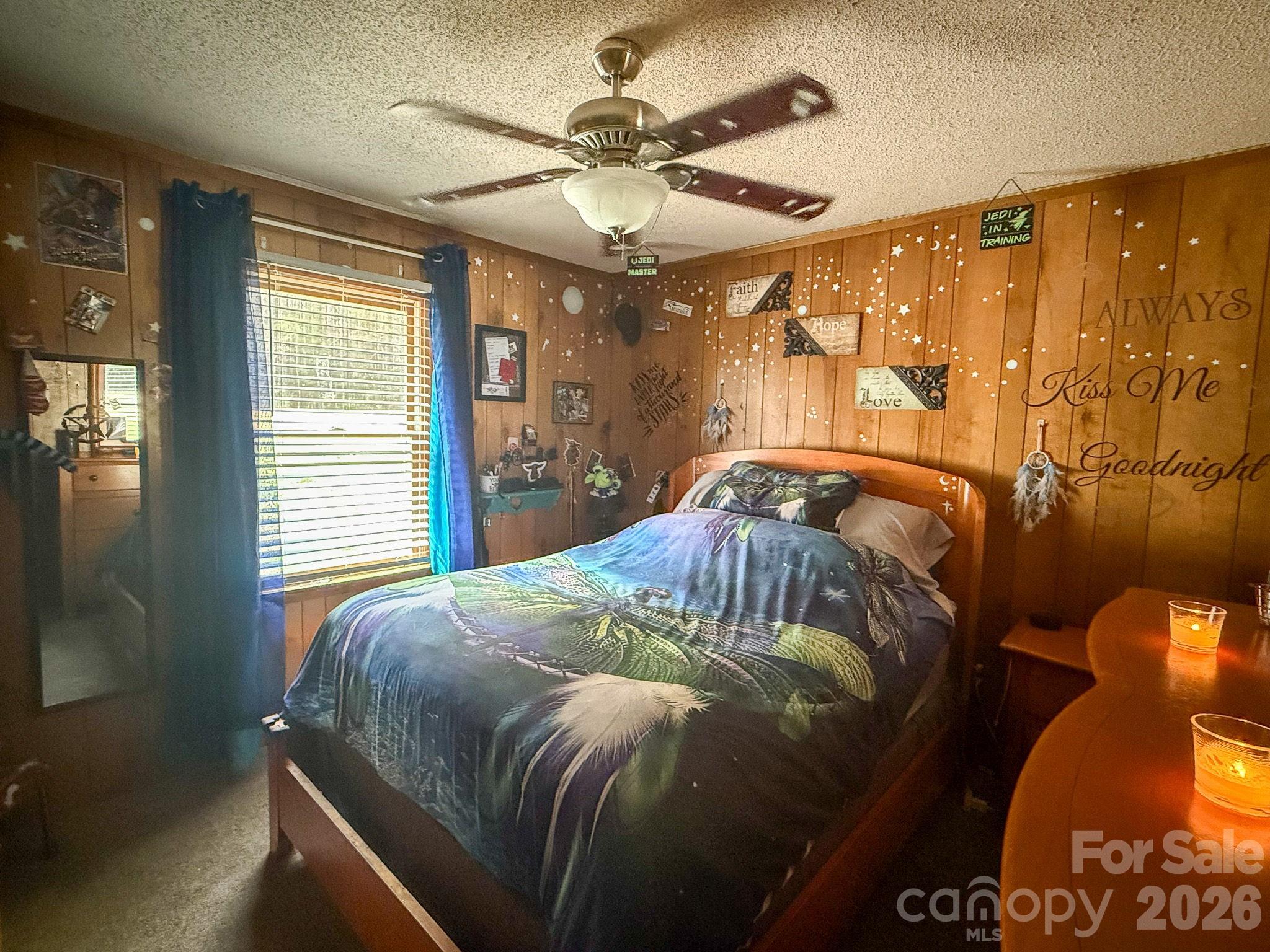 4562 Grassy Creek Road Denver, NC 28037 - Photo 22 of 24 a bedroom with a bed and wooden floor