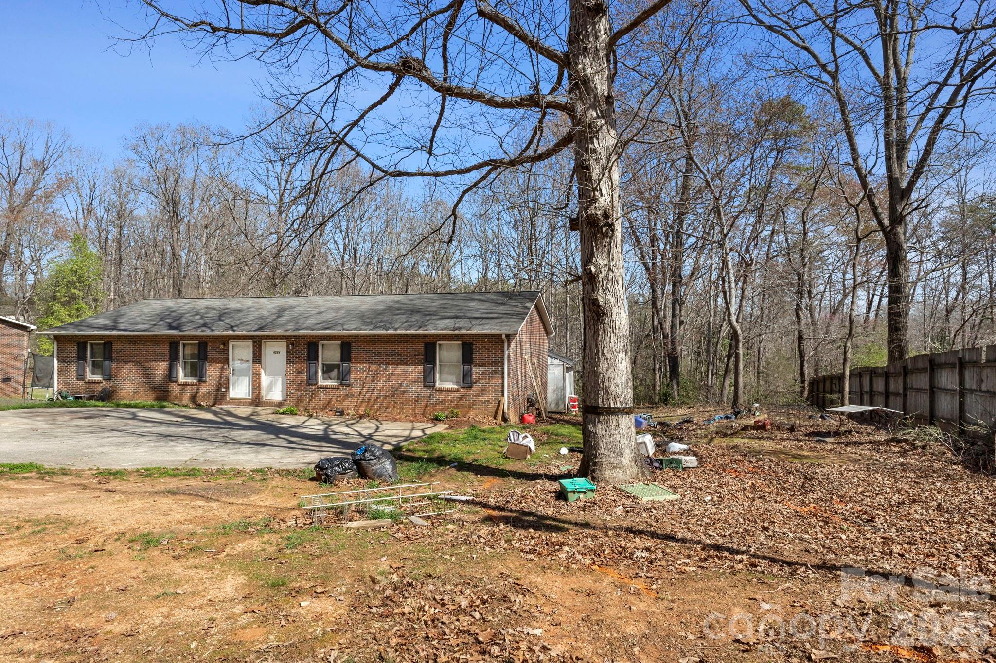 4562 Grassy Creek Road Denver, NC 28037 - Photo 4 of 24 a front view of a building with trees