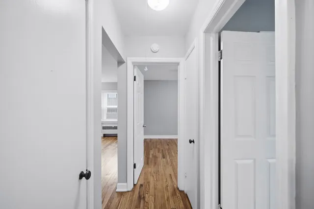 a view of hallway with wooden floor