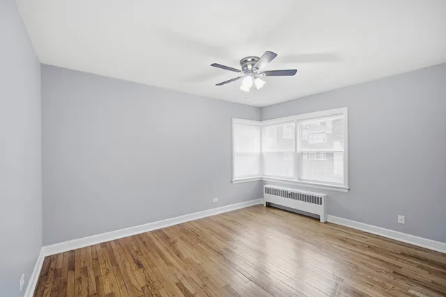a view of room with wooden floor and windows