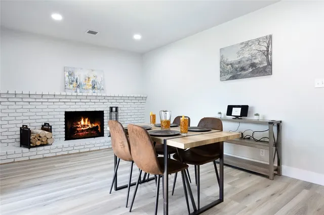 a view of a workspace with furniture and a fireplace