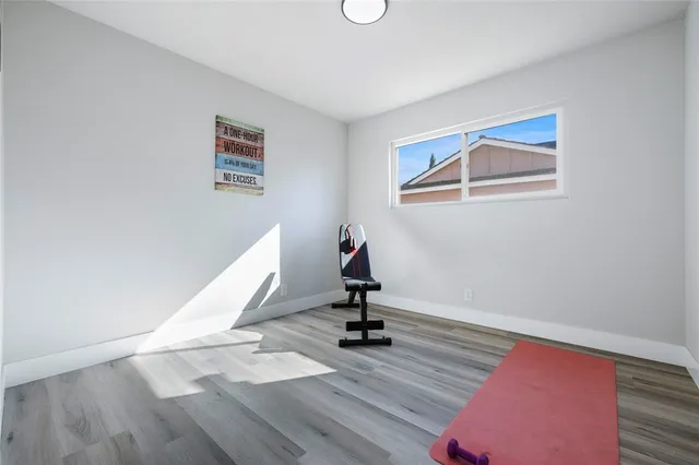 a view of a room with wooden floor