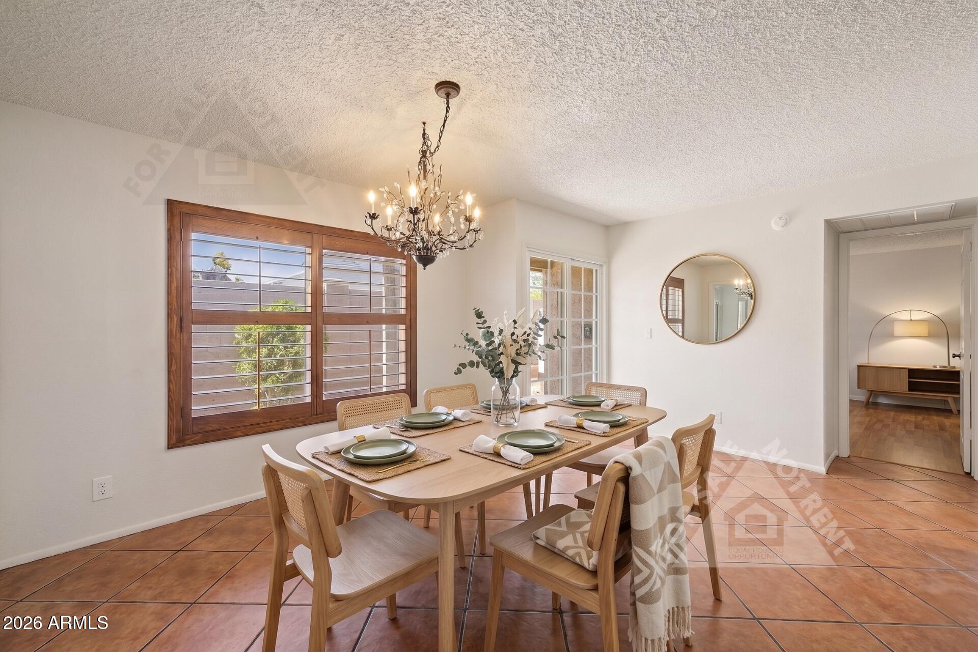 912 East Villa Rita Drive Phoenix, AZ 85022 - Photo 7 of 27 a view of a dining room with furniture a chandelier and wooden floor