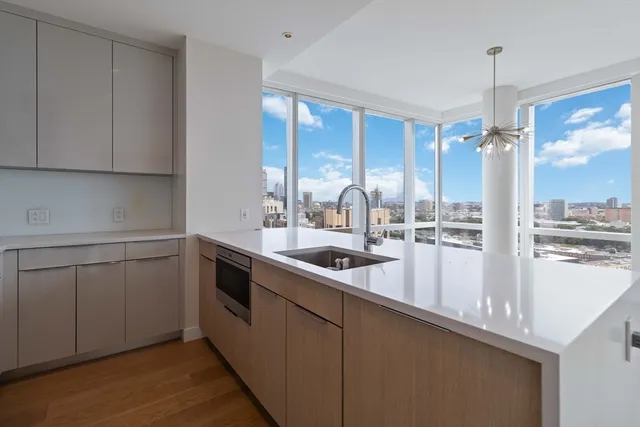 a kitchen with a sink and white cabinets