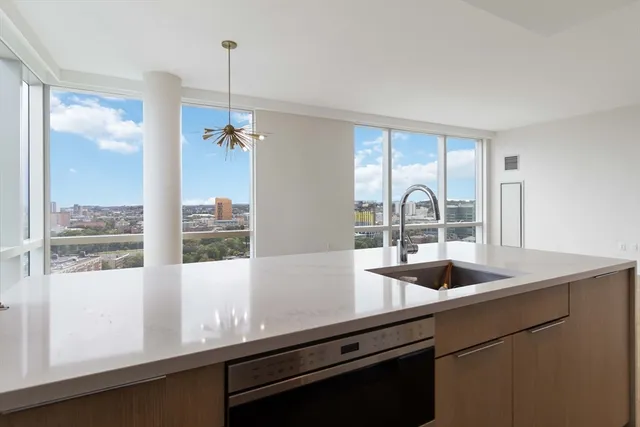a kitchen with a sink and a large window