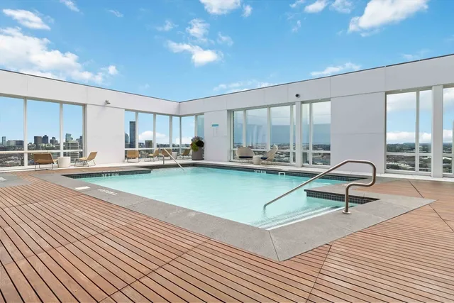 a living room with kitchen island furniture and a view of kitchen