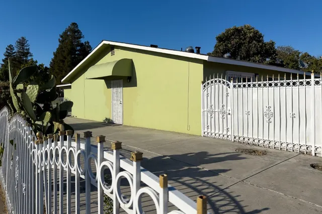 a front view of a house with a garden
