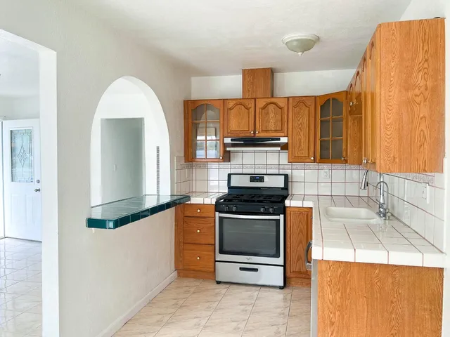 a kitchen with a stove a sink and a microwave