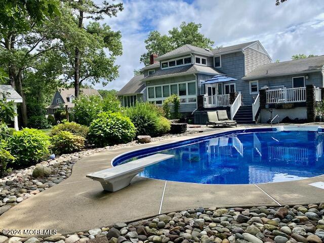732 Radcliffe Road Lanoka Harbor, NJ 08734 - Photo 56 of 67 a front view of house with yard swimming pool and trees in the background