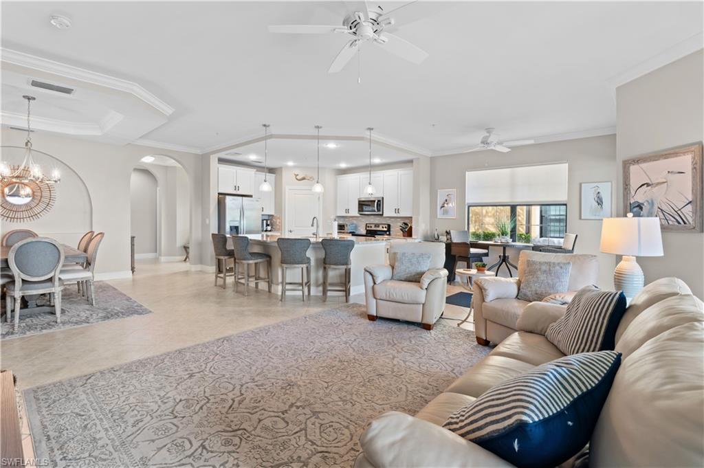 10470 Casella Way, Unit 101 Fort Myers, FL 33913 - Photo 11 of 20 a living room with furniture and a chandelier