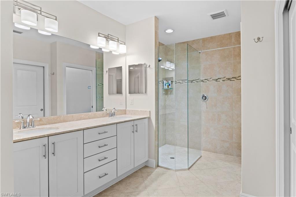 10470 Casella Way, Unit 101 Fort Myers, FL 33913 - Photo 15 of 20 a bathroom with a double vanity sink mirror and shower