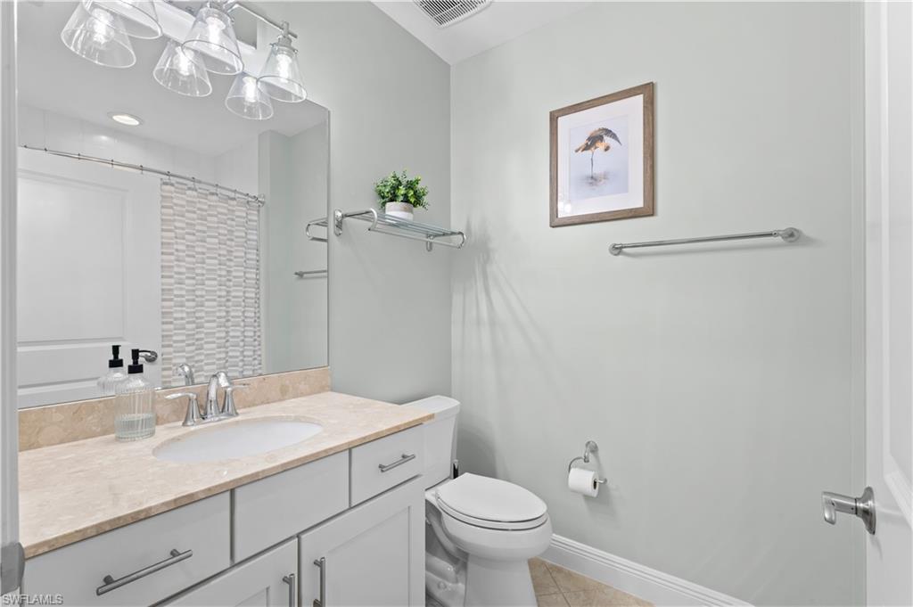 10470 Casella Way, Unit 101 Fort Myers, FL 33913 - Photo 16 of 20 a bathroom with a granite countertop sink mirror and toilet
