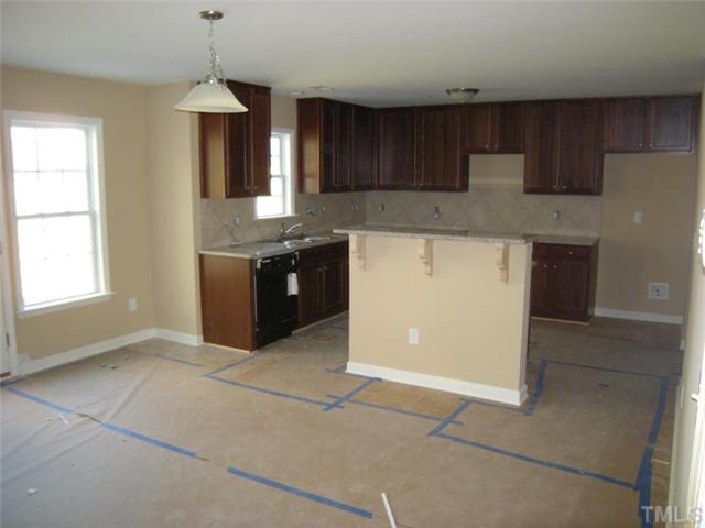 5801 Abbington Way Raleigh, NC 27610 - Photo 3 of 10 Large open kitchen with 42 in maple cabinets, granite countertops, and backsplash!