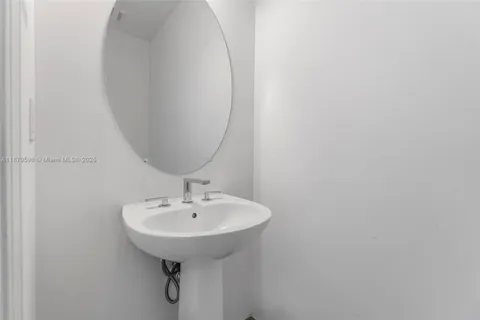 a bathroom with a sink and mirror