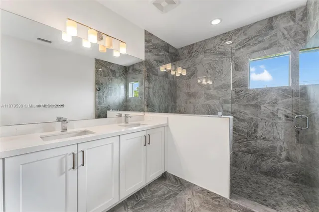 a bathroom with a double vanity sink and mirror