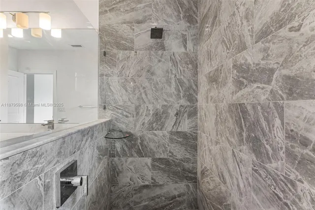 a bathroom with a granite countertop sink and a mirror