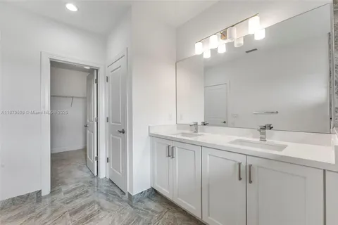 a bathroom with a double vanity sink mirror and