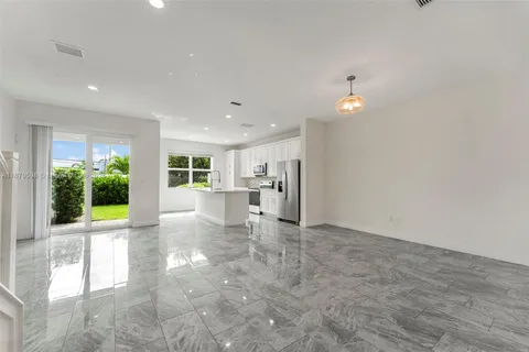 a view of a kitchen with a sink and a living room view