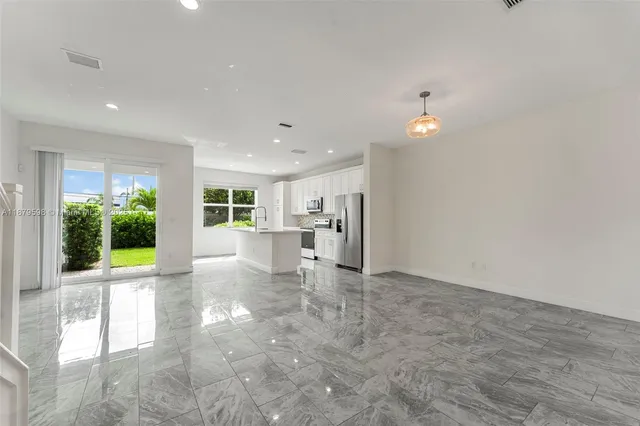 a view of a kitchen with a sink and a living room view