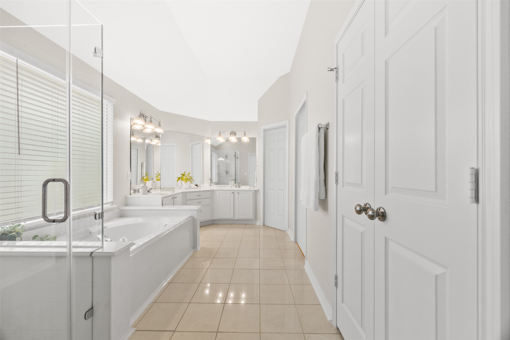 2219 Louetta Brook Lane Spring, TX 77388 - Photo 26 of 34 Spacious primary bathroom with dual vanities, soaking tub, and separate glass-enclosed shower.
