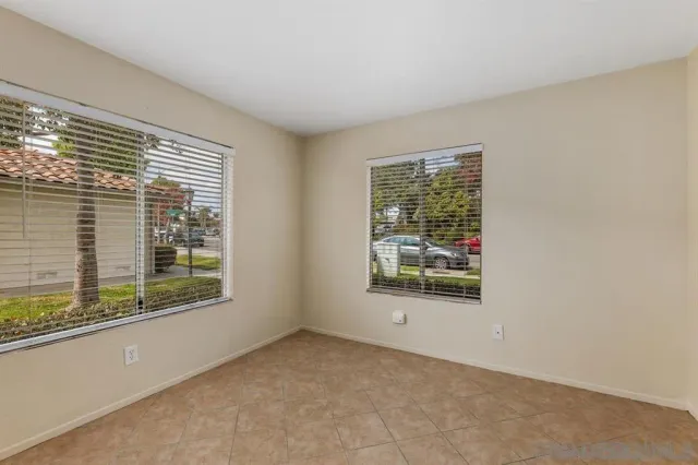 an empty room with wooden floor closet and ceiling fan