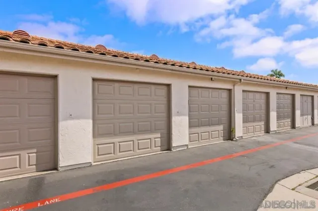an empty room with wooden floor and a ceiling fan