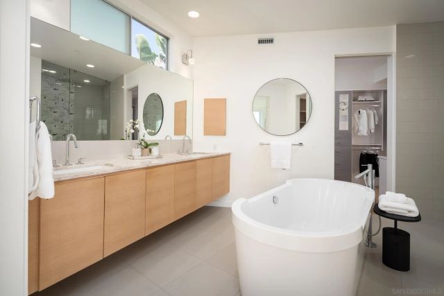 a bathroom with a double vanity sink and a mirror