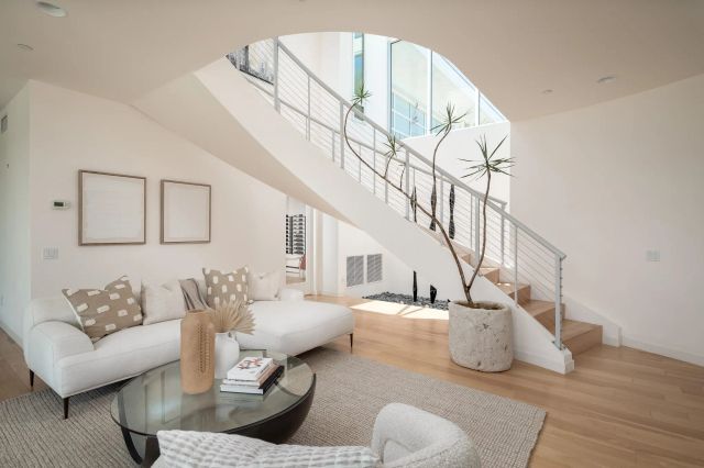 a living room with furniture and stairs