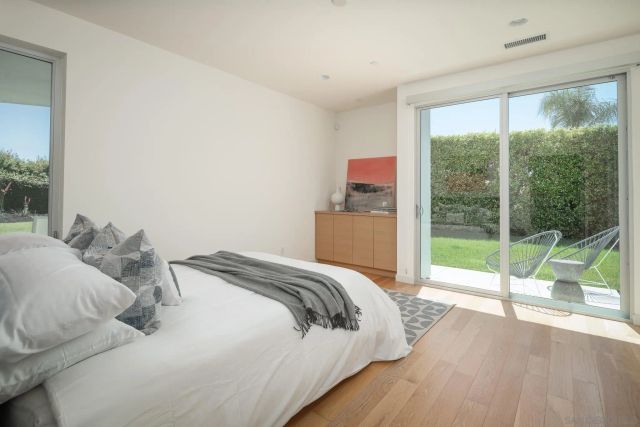 a bedroom with a bed and a large window