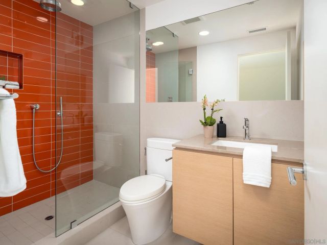 a bathroom with a toilet a sink and shower