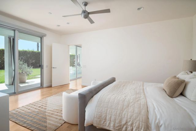 a bedroom with a bed and glass door