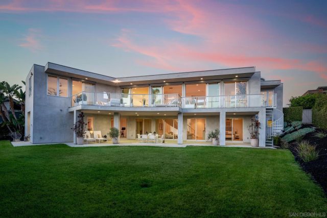 a front view of a house with garden and outdoor seating
