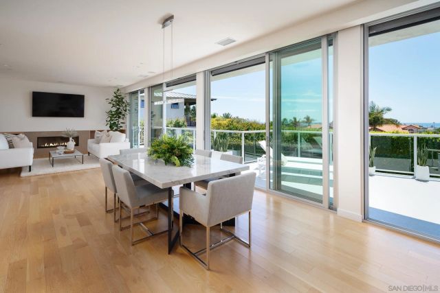 a dining room with furniture window and wooden floor