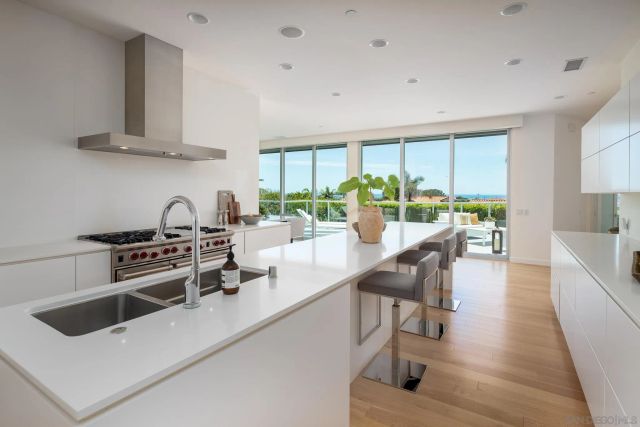 a kitchen with a stove a refrigerator and a dining table