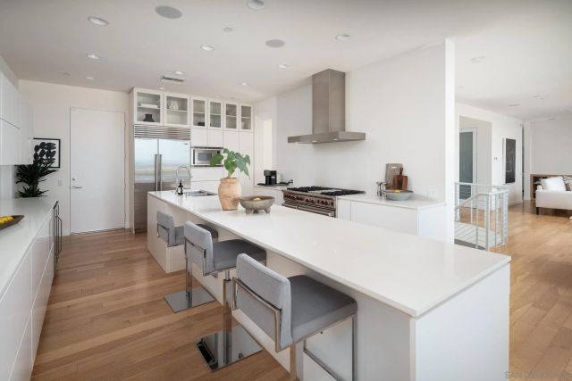 a kitchen with a sink a stove a refrigerator and cabinets