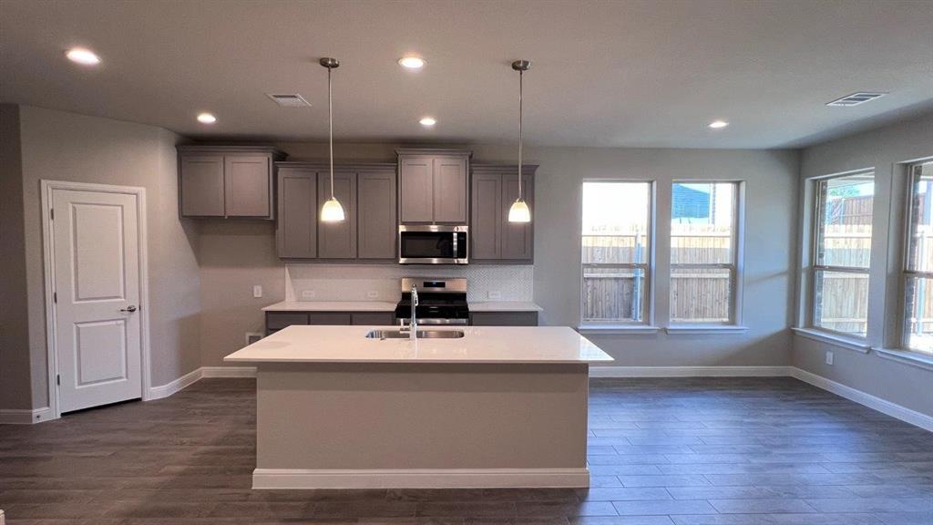 129 Medina Lane Rhome, TX 76078 - Photo 11 of 13 a view of kitchen with wooden floor and window