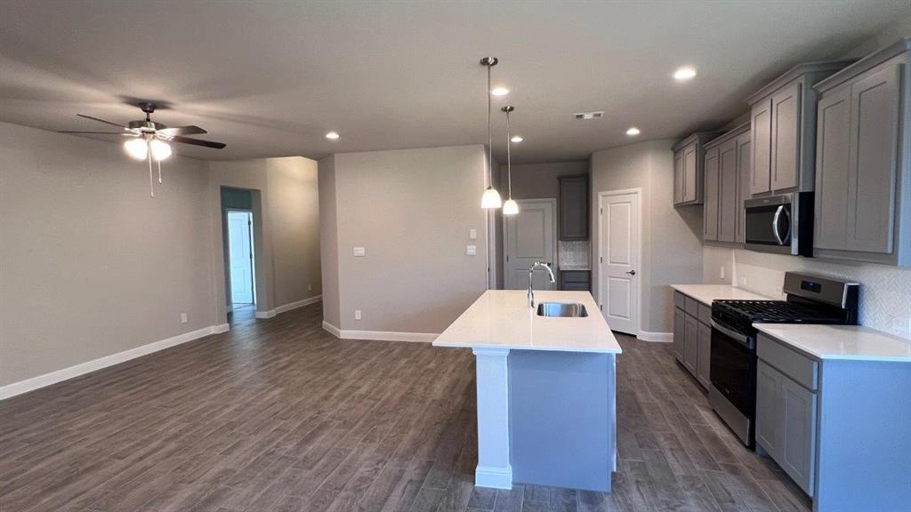 129 Medina Lane Rhome, TX 76078 - Photo 1 of 13 a large kitchen with stainless steel appliances kitchen island a large island in the center