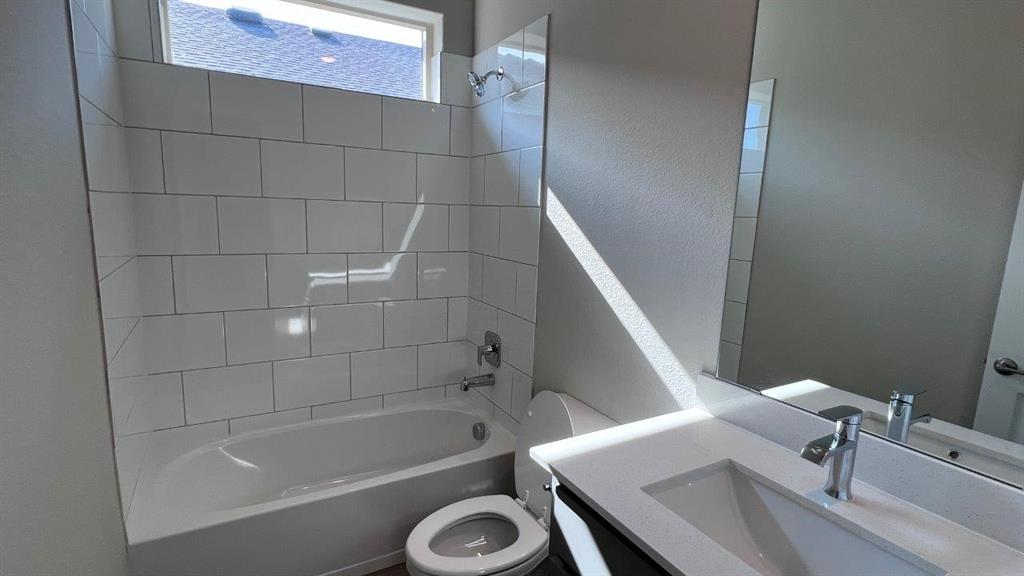 129 Medina Lane Rhome, TX 76078 - Photo 7 of 13 a bathroom with a tub a sink and a toilet