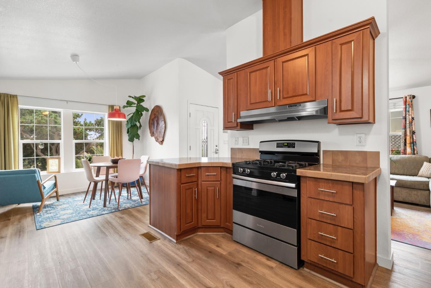 2395 Delaware Avenue, Unit 88 Santa Cruz, CA 95060 - Photo 11 of 55 a kitchen with stainless steel appliances granite countertop a stove top oven a sink dishwasher a dining table and chairs with wooden floor