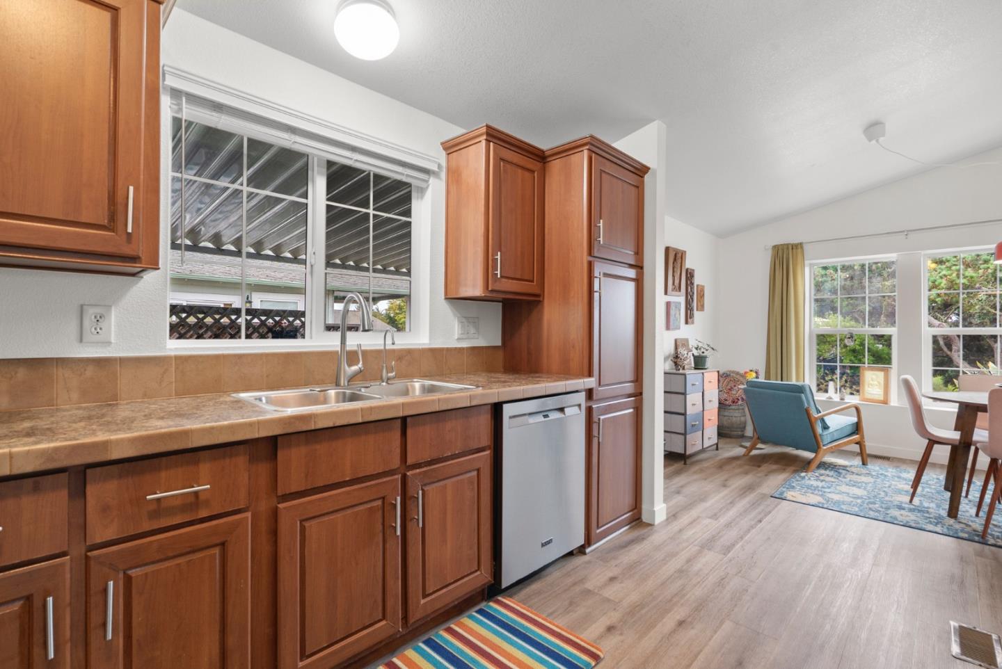 2395 Delaware Avenue, Unit 88 Santa Cruz, CA 95060 - Photo 12 of 55 a kitchen with stainless steel appliances a sink cabinets and wooden floor