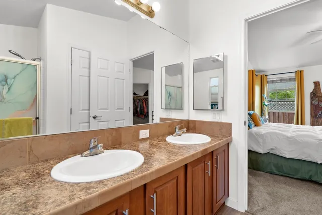 a bathroom with a double vanity sink and a mirror