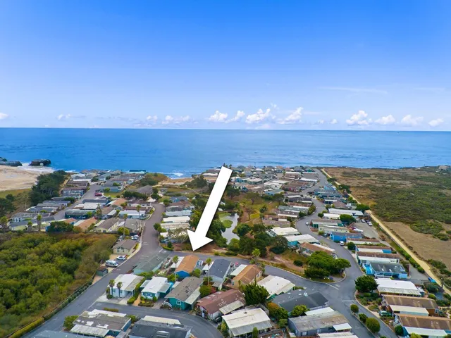 an aerial view of a house with a ocean view