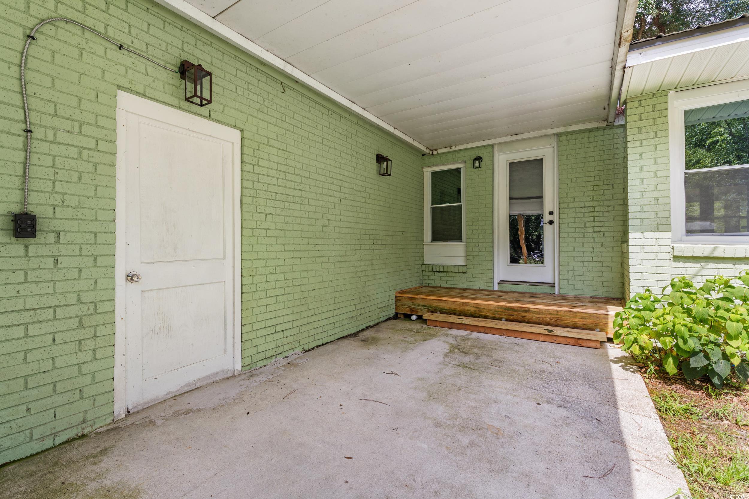 3974 North Fraser Street Georgetown, SC 29440 - Photo 21 of 36 Entrance to property with brick siding and a patio area