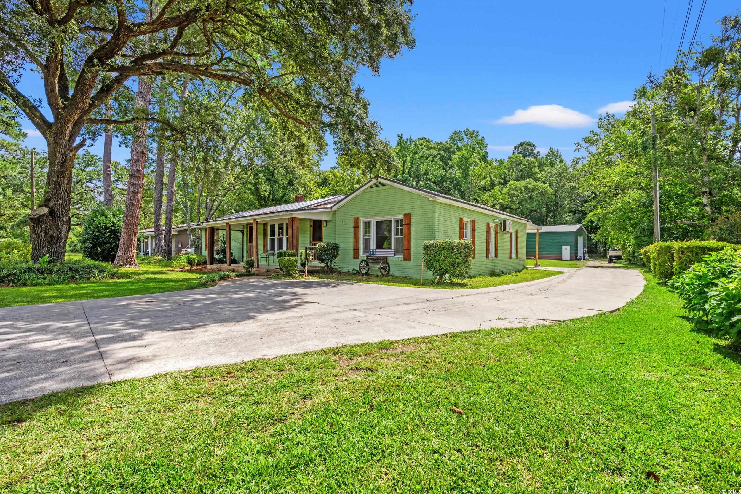 3974 North Fraser Street Georgetown, SC 29440 - Photo 26 of 36 Ranch-style house featuring a porch, driveway, and a front lawn