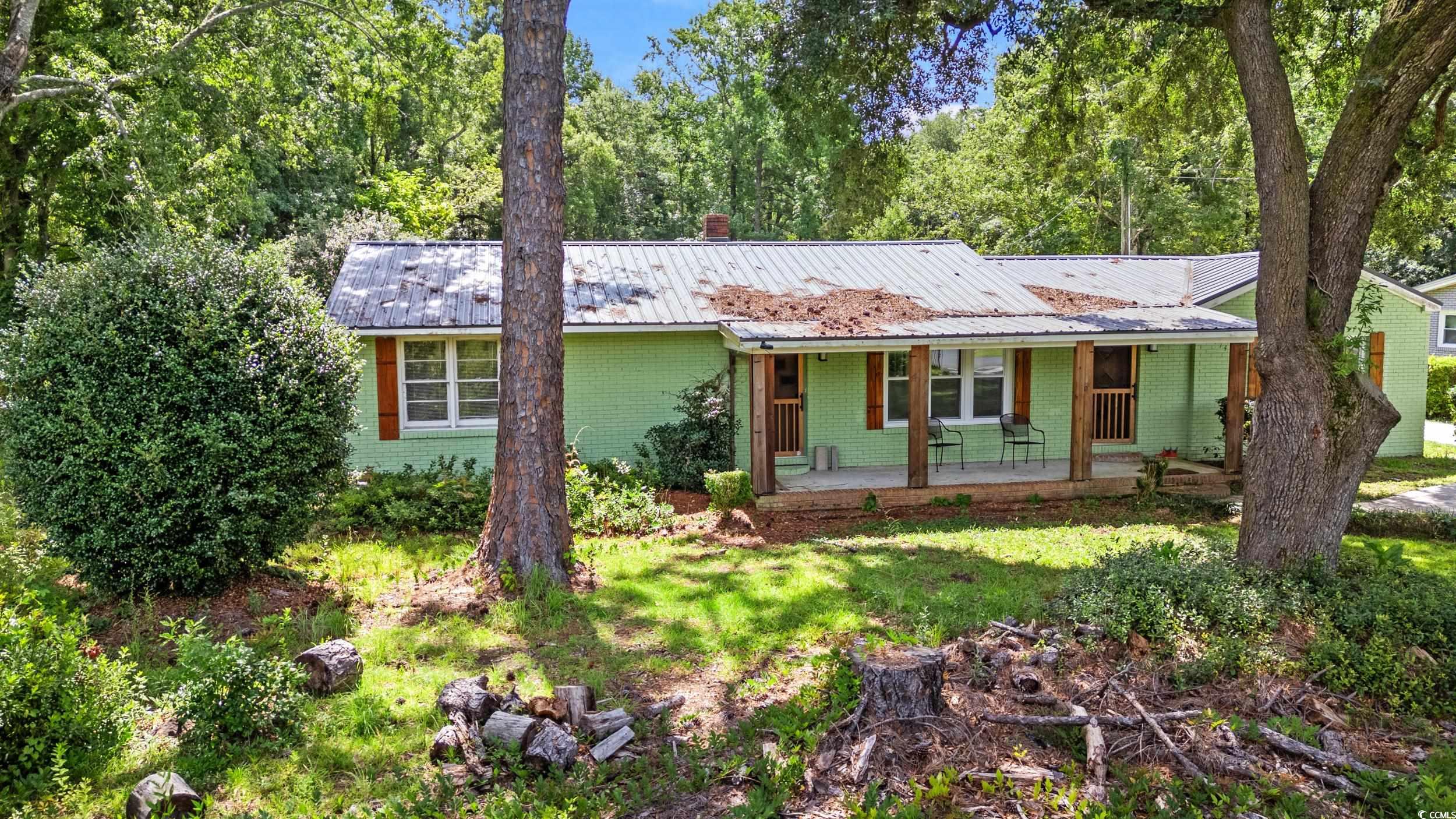 3974 North Fraser Street Georgetown, SC 29440 - Photo 29 of 36 Single story home with a metal roof, a porch, and brick siding