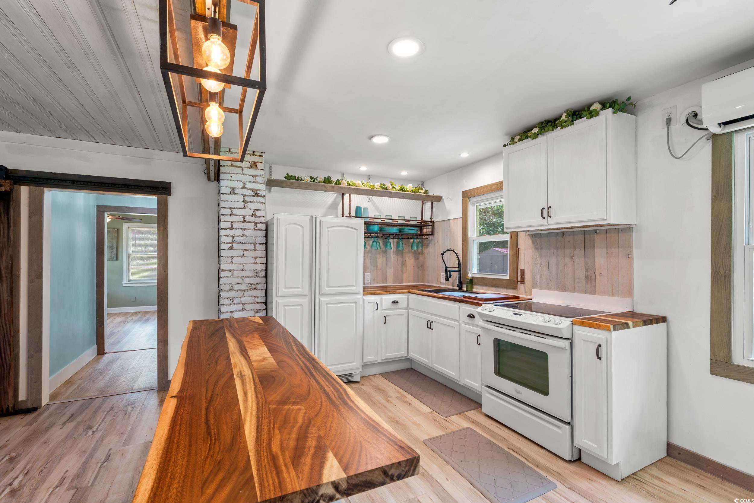 3974 North Fraser Street Georgetown, SC 29440 - Photo 3 of 36 Kitchen with open shelves, electric stove, white cabinets, light wood-style floors, and recessed lighting