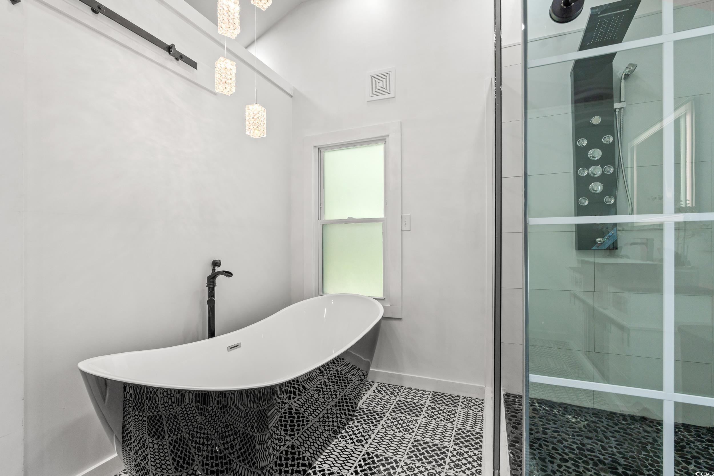 3974 North Fraser Street Georgetown, SC 29440 - Photo 5 of 36 Bathroom featuring a stall shower, a freestanding bath, and tile patterned flooring
