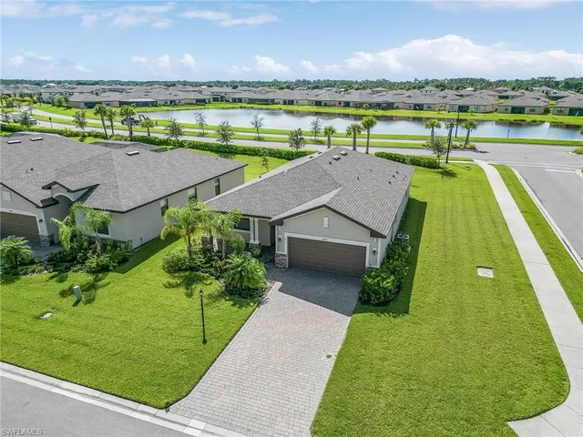 an aerial view of a house with a big yard