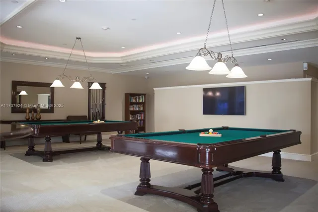 a room with pool table and windows