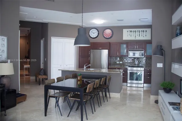 a kitchen with a table and chairs in it